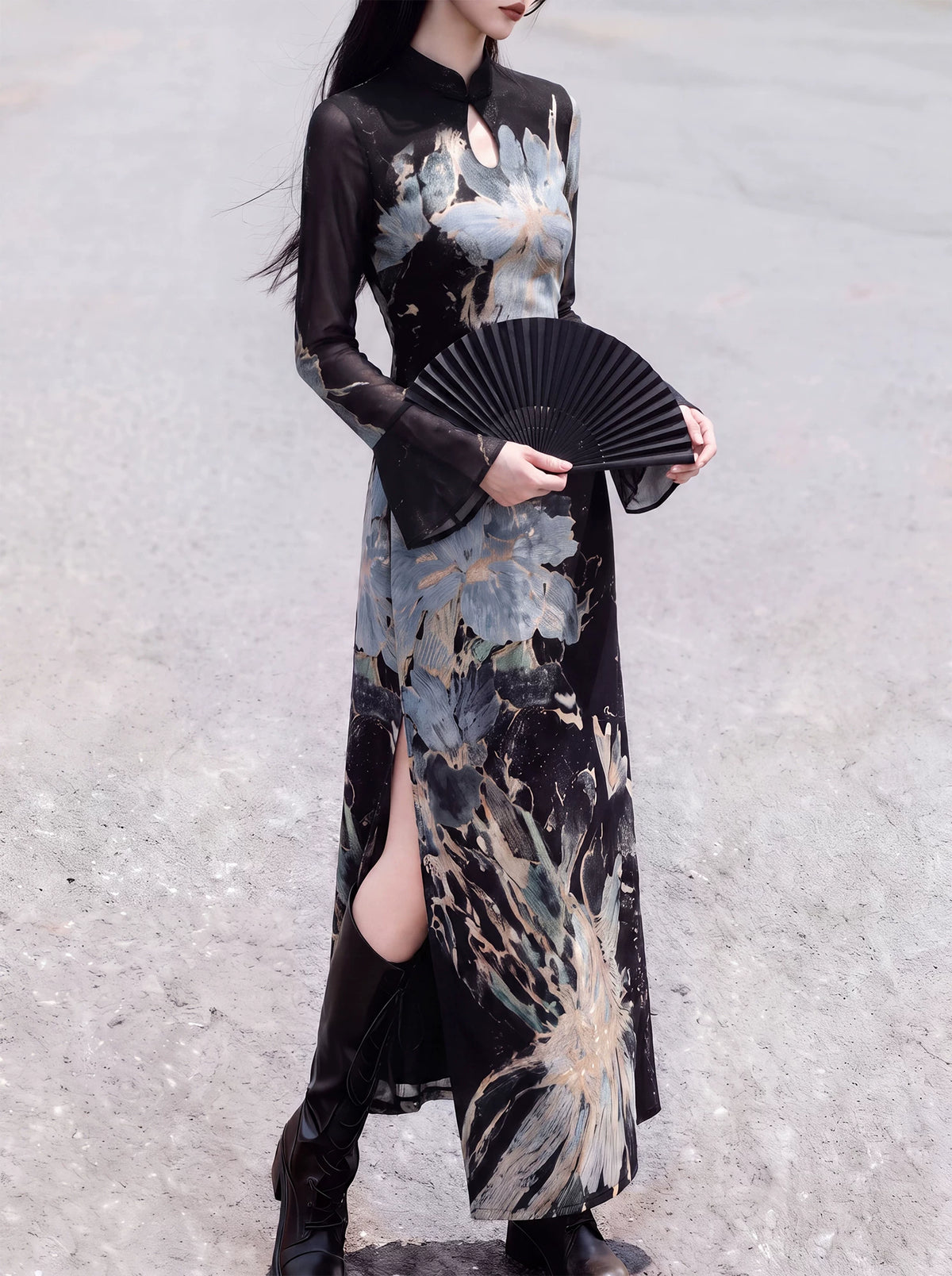 Front view of the black floral qipao styled with a folding fan