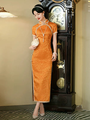 Full-length orange vintage-style cheongsam showing its fitted silhouette and pale hem edging