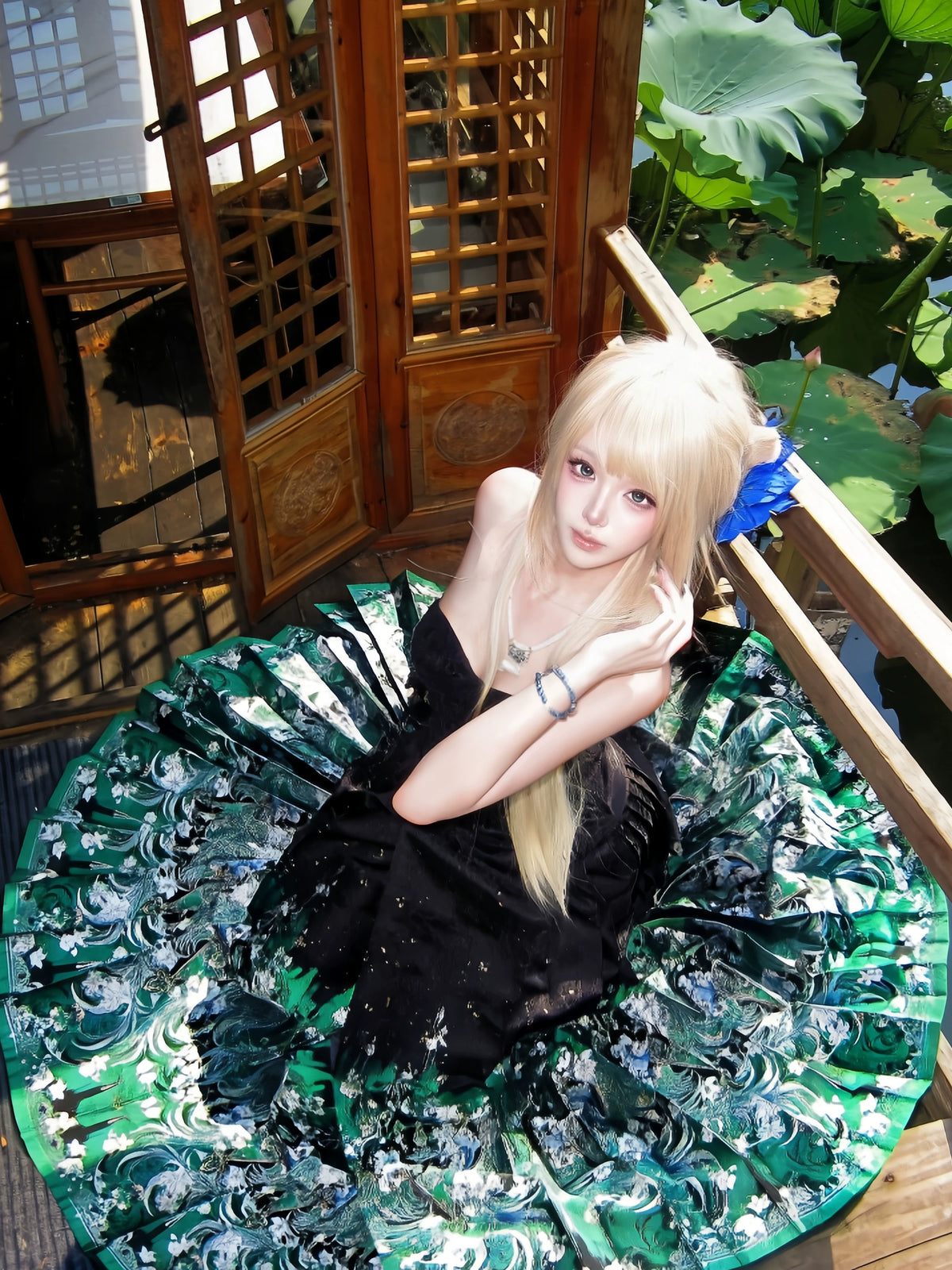 Green and silver brocade wrap skirt worn seated