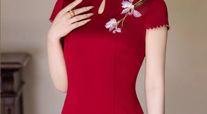 Close-up of stand collar, teardrop neckline and iris embroidery