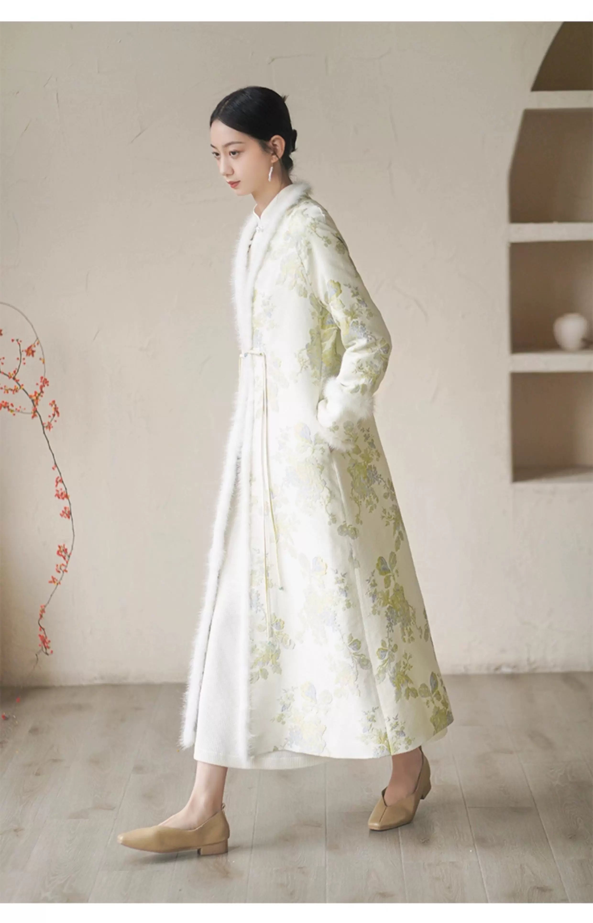 Additional styling view of the Ivory-Green woven floral wool-blend long coat, showing the garment's shape, texture and finish.