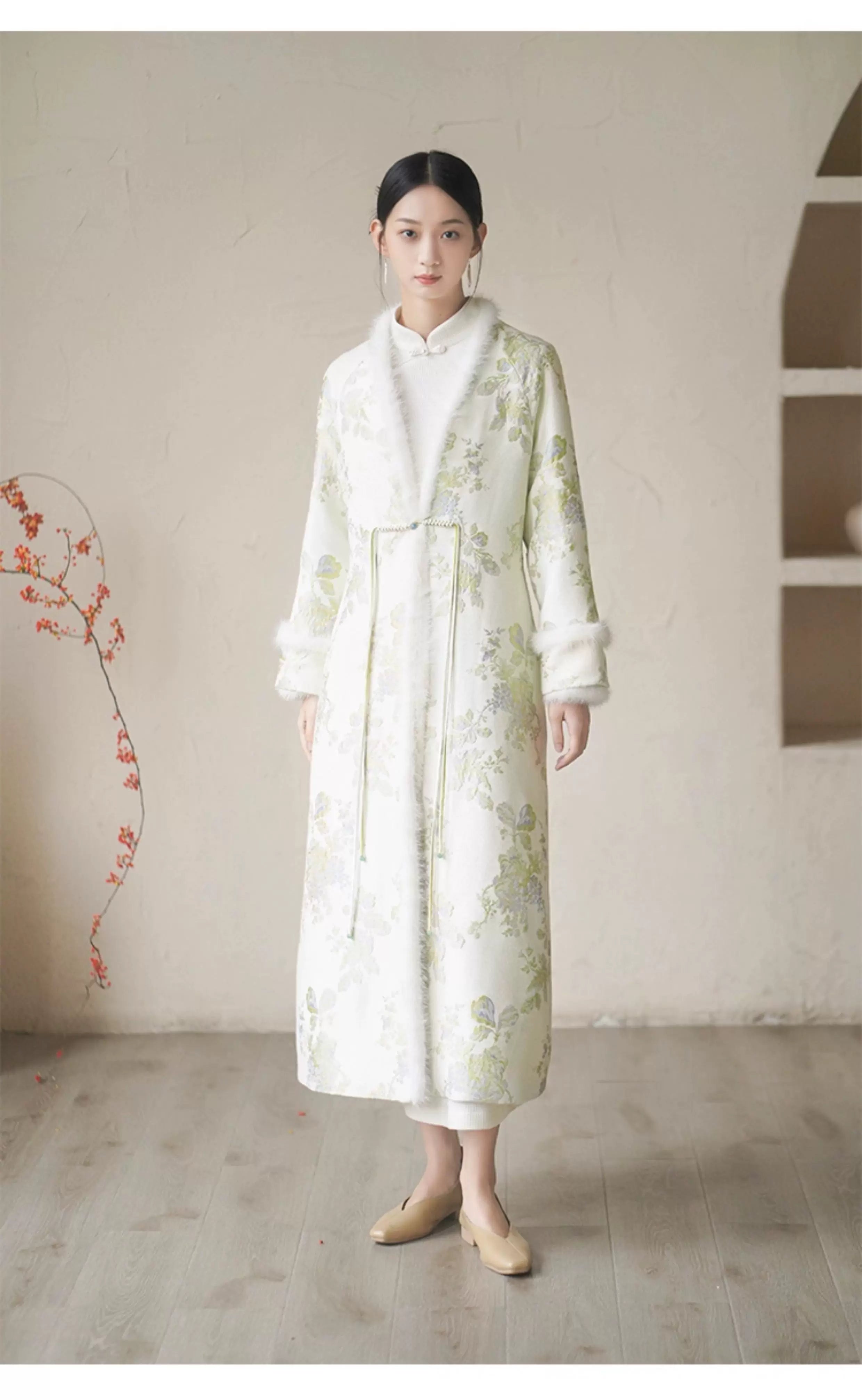 Front styling view of the Ivory-Green woven floral wool-blend long coat, with woven floral pattern, wool-blend texture and elegant long-line shape.
