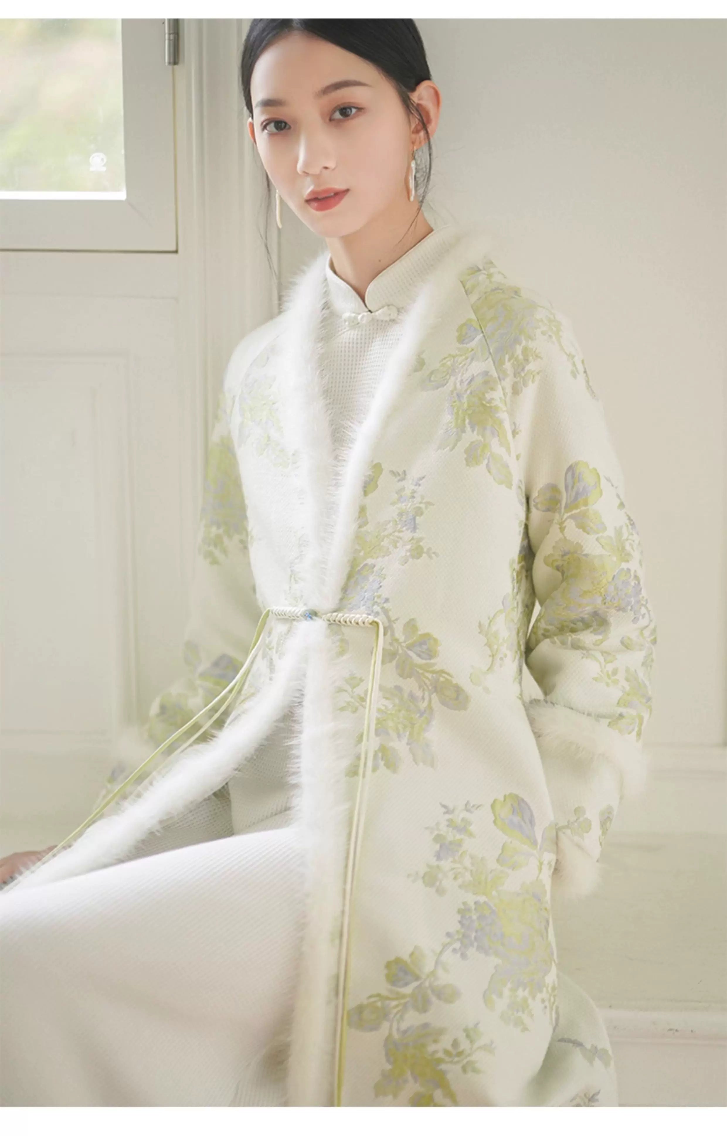 Three-quarter product view of the Ivory-Green woven floral wool-blend long coat, a refined New Chinese Style coat for elegant occasions.