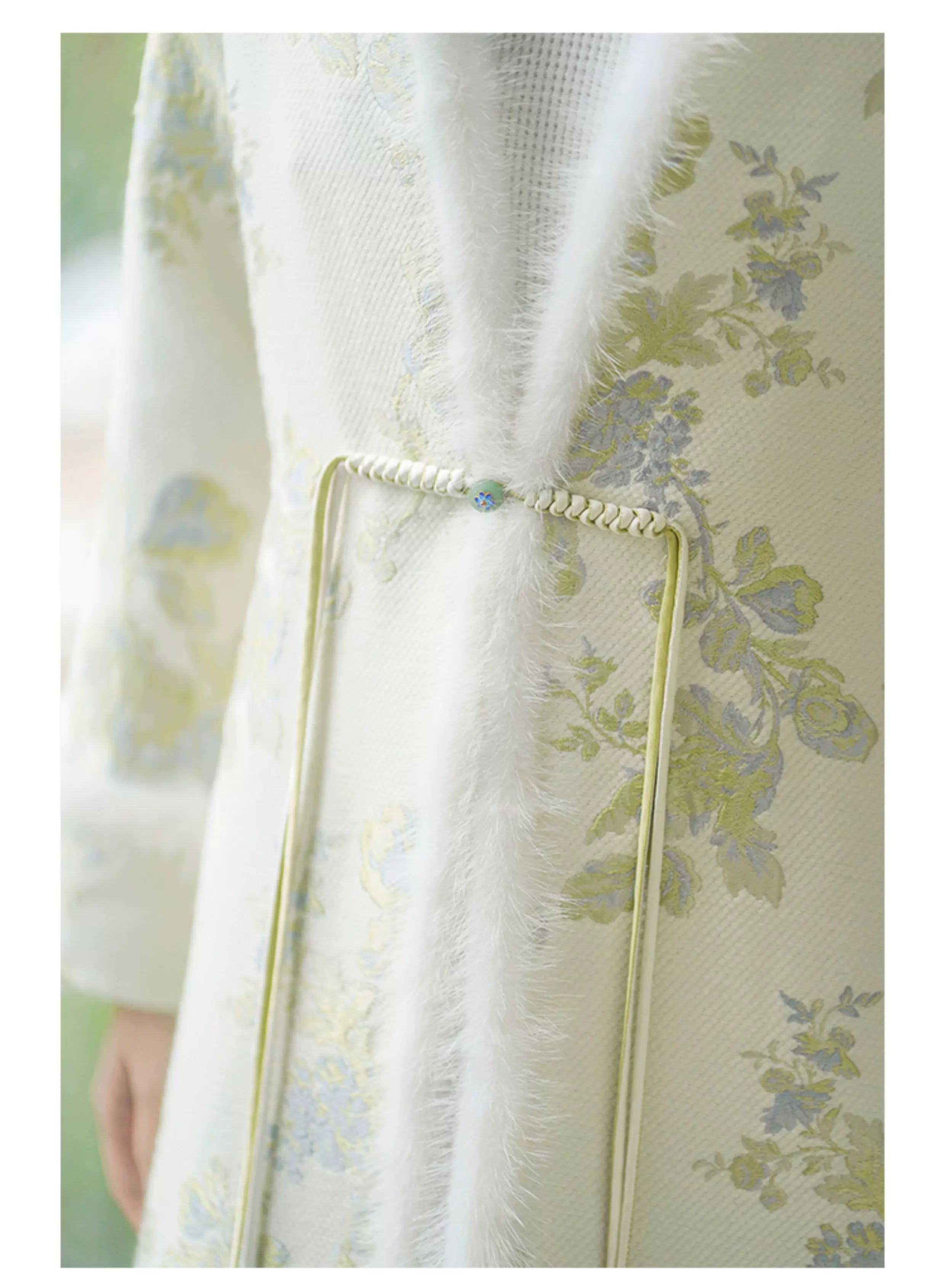 Ivory-Green woven floral wool-blend long coat styled to show its fit and drape, including woven floral pattern, wool-blend texture and elegant long-line shape.