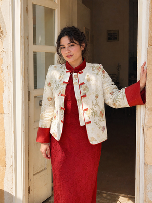 Ivory jacquard padded jacket and red qipao natural doorway view on Western model