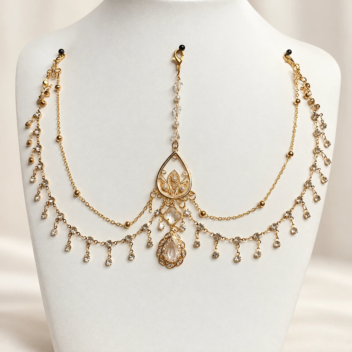 Clear forehead chain on a display bust