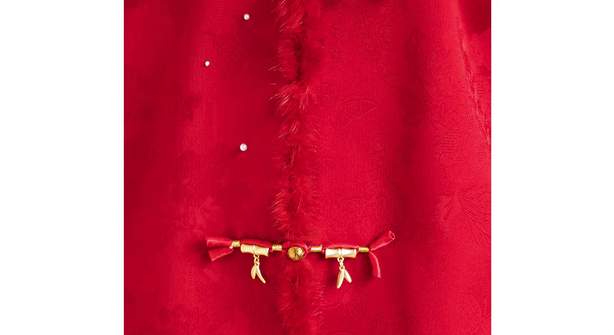 Red floral jacket fabric and gold-tone bar fastening