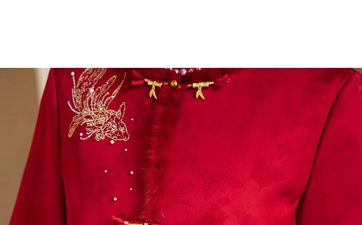 Gold-tone bird embellishment and front fastening on red bridal jacket
