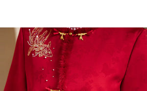 Gold-tone bird embellishment and front fastening on red bridal jacket