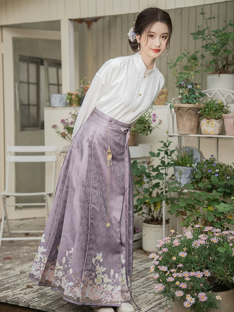 Purple floral mamian skirt and white cross-collar blouse beside potted flowers