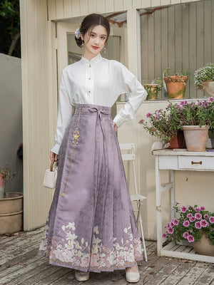 Front view of the purple magnolia skirt with a white standing-collar blouse