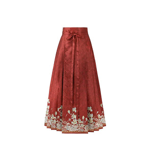 Red magnolia mamian skirt with a cream floral border and tie waistband
