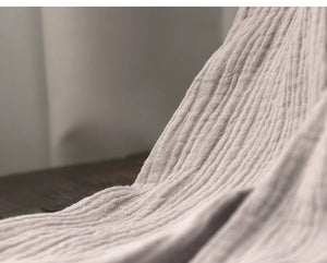 Folded gray top and pants set showing breathable cotton gauze construction