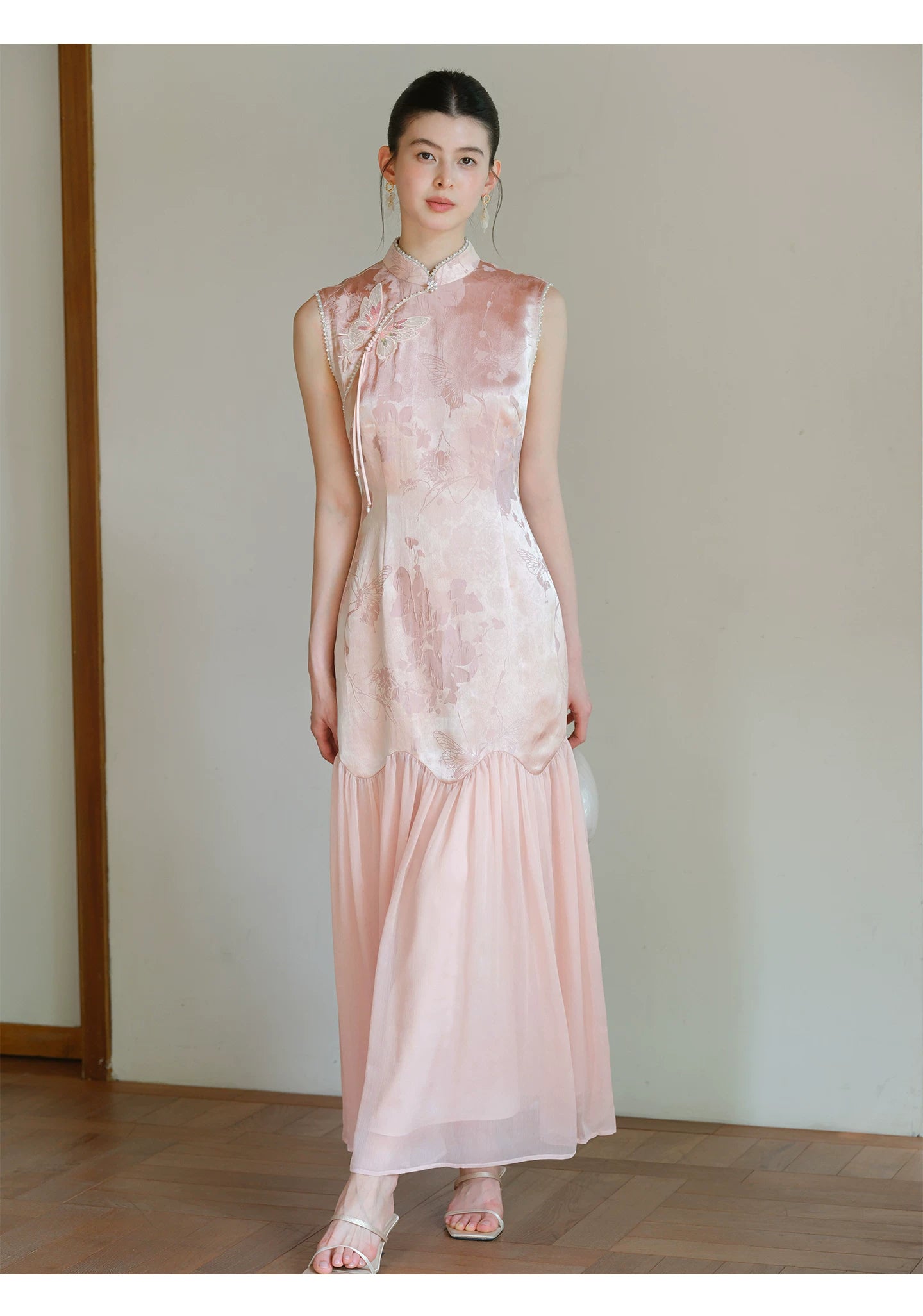 Misty Blush floral jacquard cheongsam dress styled to show its fit and drape, including floral jacquard texture, fitted waist and elegant long silhouette.