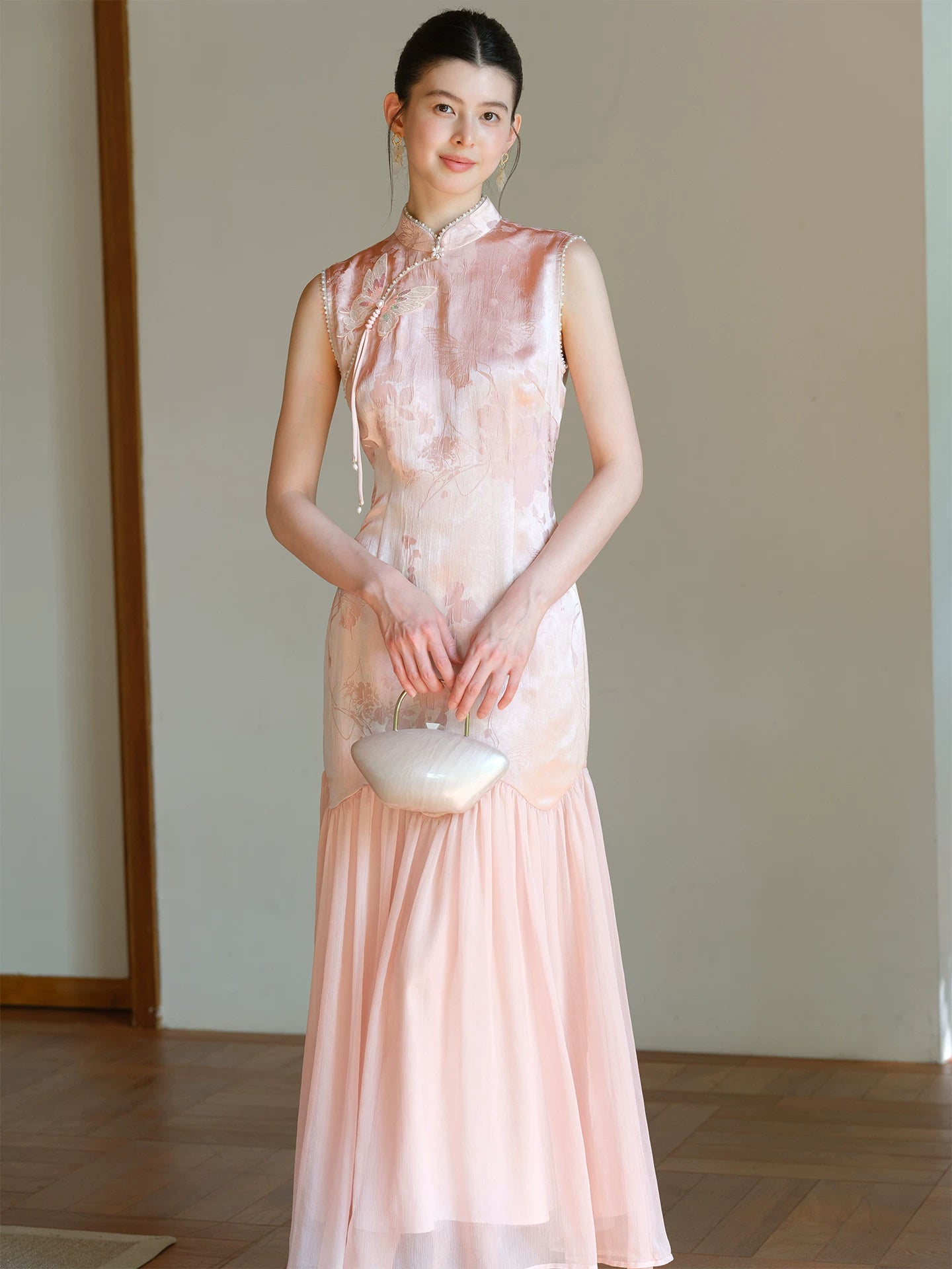 Front styling view of the Misty Blush floral jacquard cheongsam dress, with floral jacquard texture, fitted waist and elegant long silhouette.