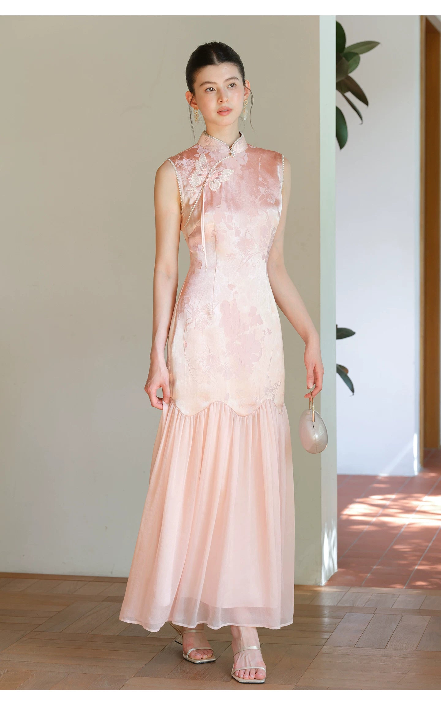 Misty Blush floral jacquard cheongsam dress styled to show its fit and drape, including floral jacquard texture, fitted waist and elegant long silhouette.