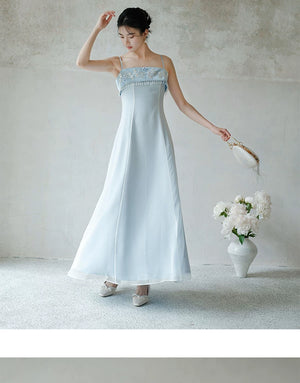Front styling view of the Moonlight Blue embroidered A-line slip dress, with delicate embroidery, clean A-line shape and elegant blue palette.