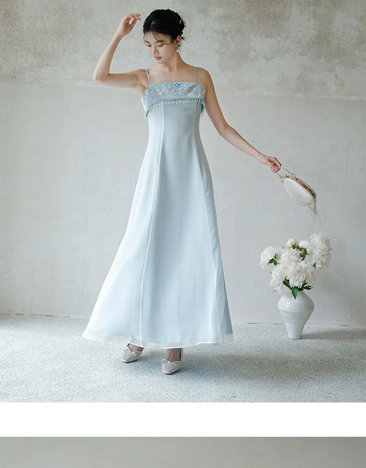Front styling view of the Moonlight Blue embroidered A-line slip dress, with delicate embroidery, clean A-line shape and elegant blue palette.