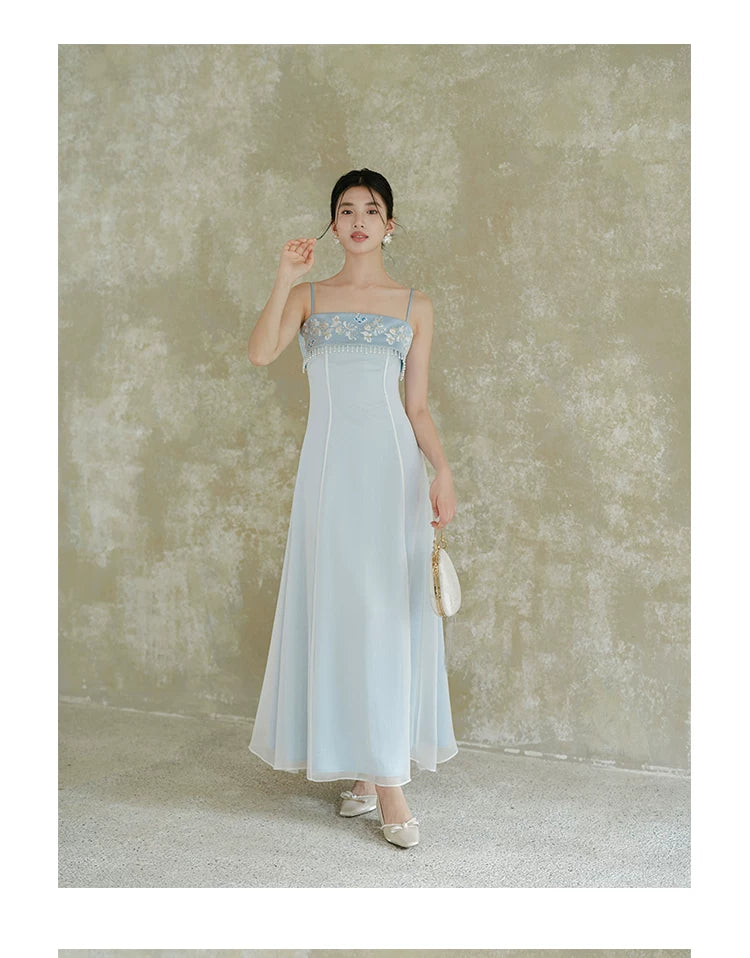 Moonlight Blue embroidered A-line slip dress styled to show its fit and drape, including delicate embroidery, clean A-line shape and elegant blue palette.