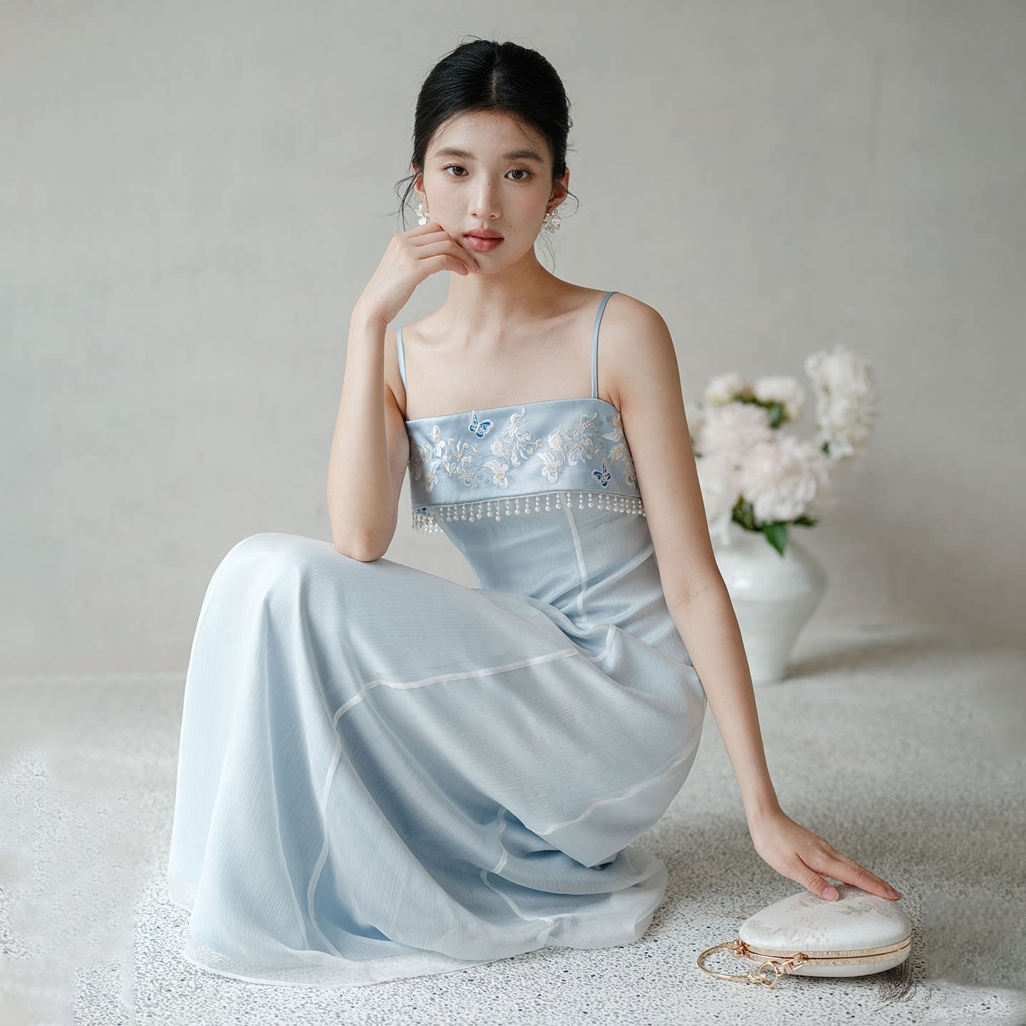 Close product view of the Moonlight Blue embroidered A-line slip dress, focused on its Chinese-inspired design details.