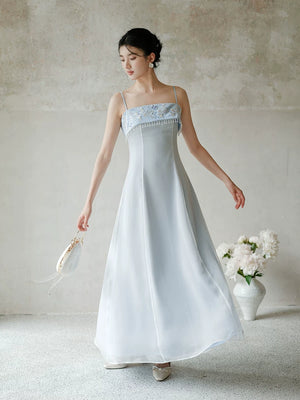 Front styling view of the Moonlight Blue embroidered A-line slip dress, with delicate embroidery, clean A-line shape and elegant blue palette.