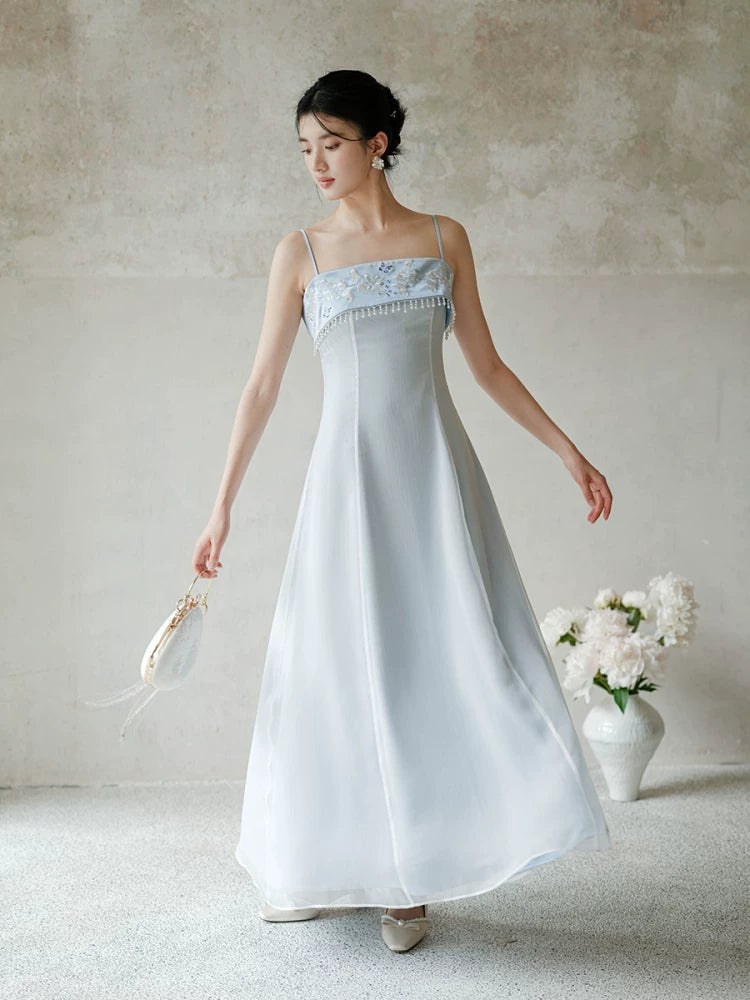 Front styling view of the Moonlight Blue embroidered A-line slip dress, with delicate embroidery, clean A-line shape and elegant blue palette.