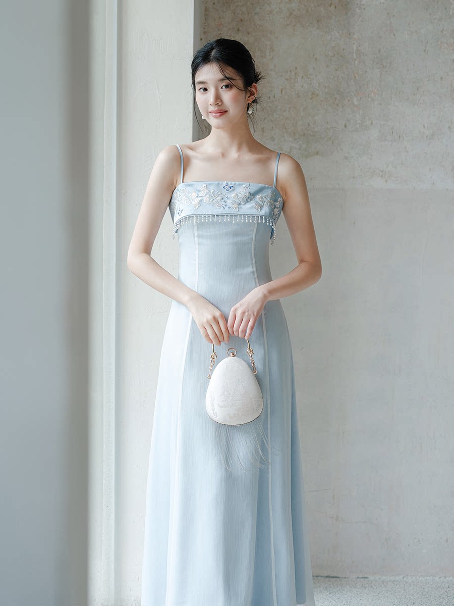 Three-quarter product view of the Moonlight Blue embroidered A-line slip dress, a refined modern Chinese dress for elegant occasions.