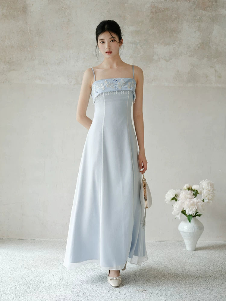 Moonlight Blue embroidered A-line slip dress styled to show its fit and drape, including delicate embroidery, clean A-line shape and elegant blue palette.