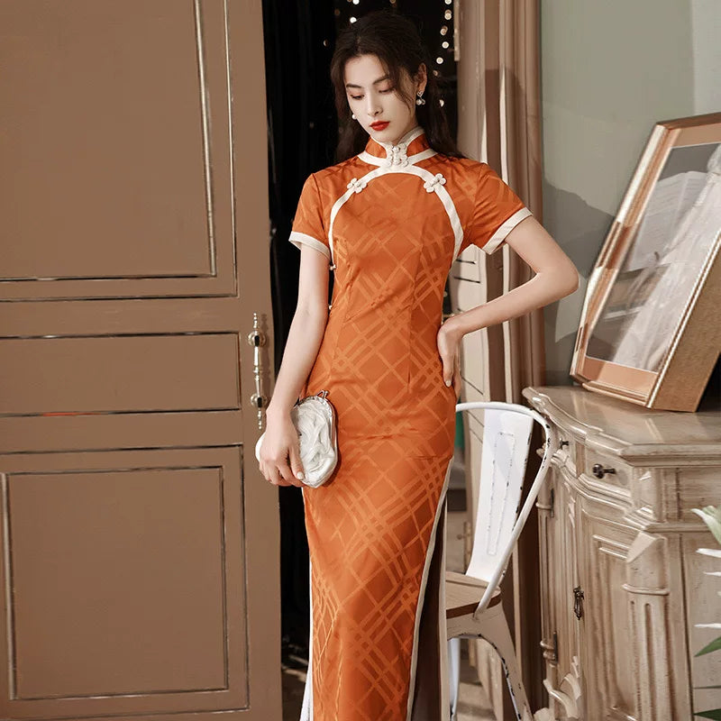 Orange diamond-pattern qipao with short sleeves and contrasting white curved trim