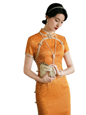 Orange qipao bodice on a white background showing the stand collar and rounded front trim