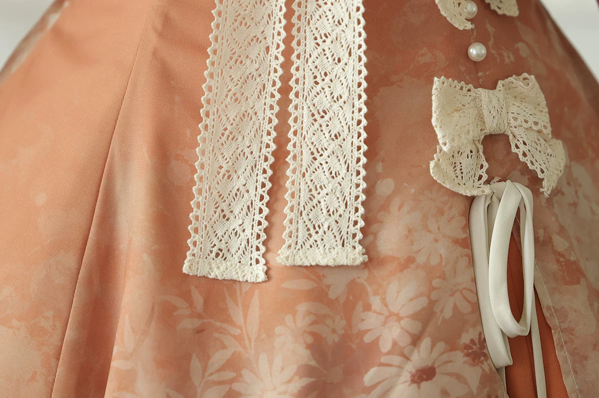 Peach floral slip dress waist detail showing fixed ivory bows and a hanging decorative cord