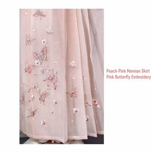 Peach-pink mamian skirt close-up with pink butterflies and small floral embroidery