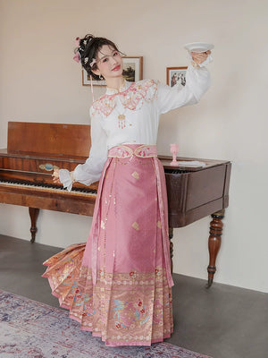 Pink cloud-collar Hanfu outfit with a white blouse and magpie mamian skirt beside a piano