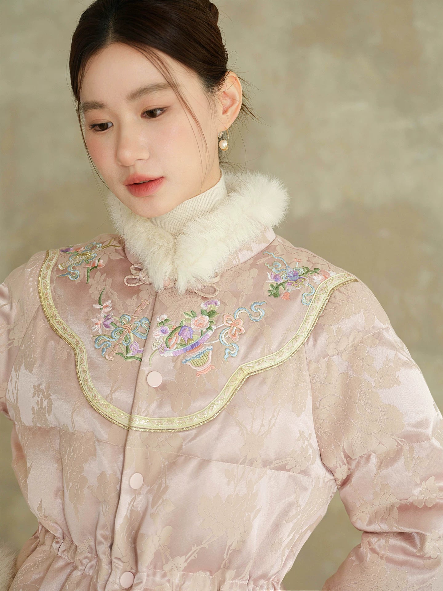 Design view of the Pink-Lilac jacquard down jacket with fur trim, highlighting jacquard shell, plush fur trim and warm cropped silhouette.