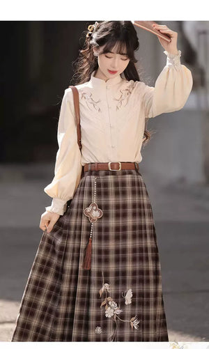 Two-piece blouse and plaid skirt outfit showing gathered sleeves and the hanging ornament