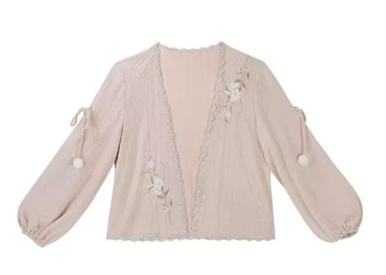 Blush pink cardigan with floral embroidery, textured fabric and pom-pom sleeve ties