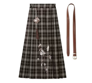 Brown plaid floral skirt displayed with its waist belt and hanging ornament