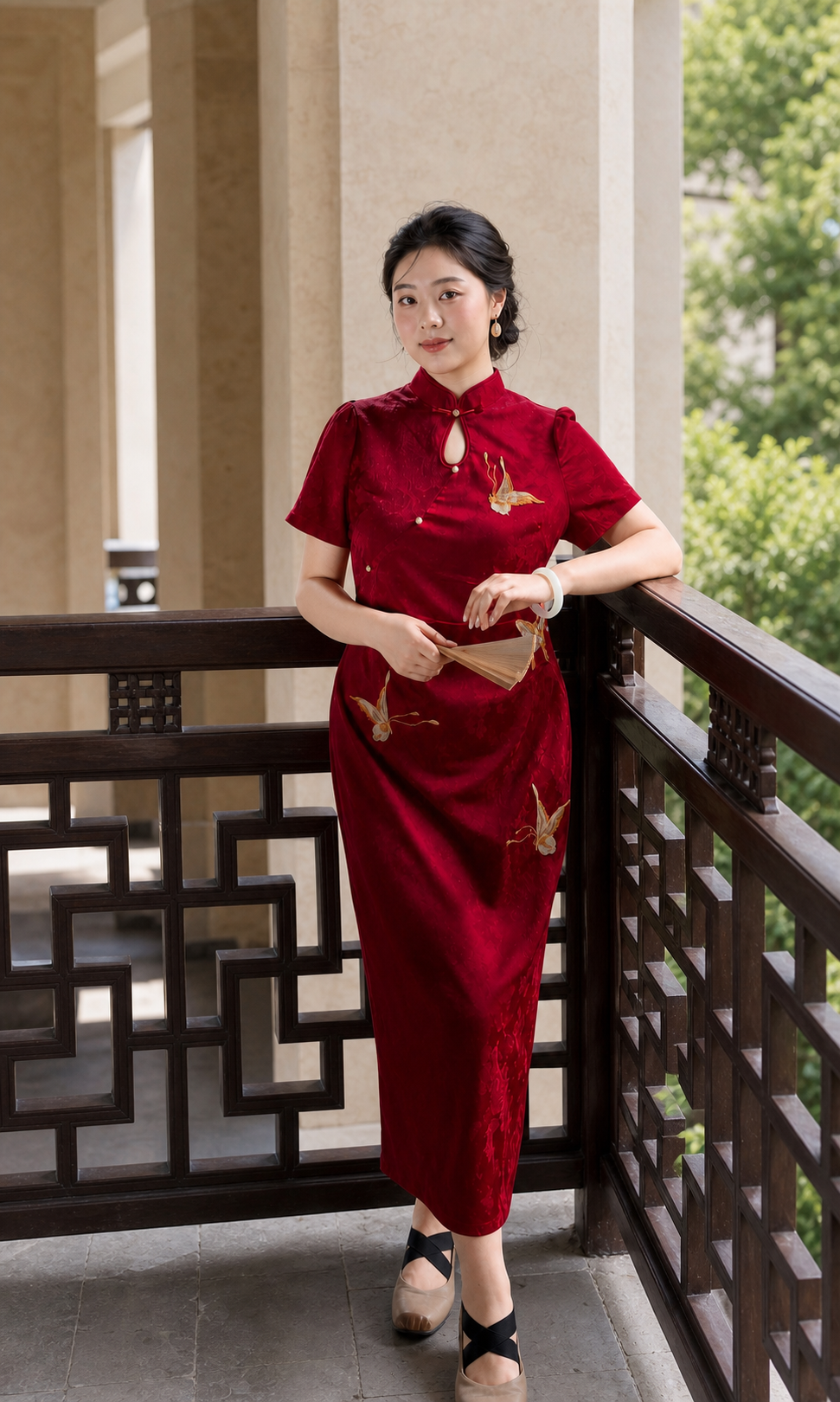 Red butterfly jacquard qipao, alternate full standing view with fan