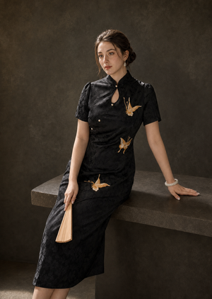 Black butterfly jacquard cheongsam seated view showing fit, sheen and embroidery