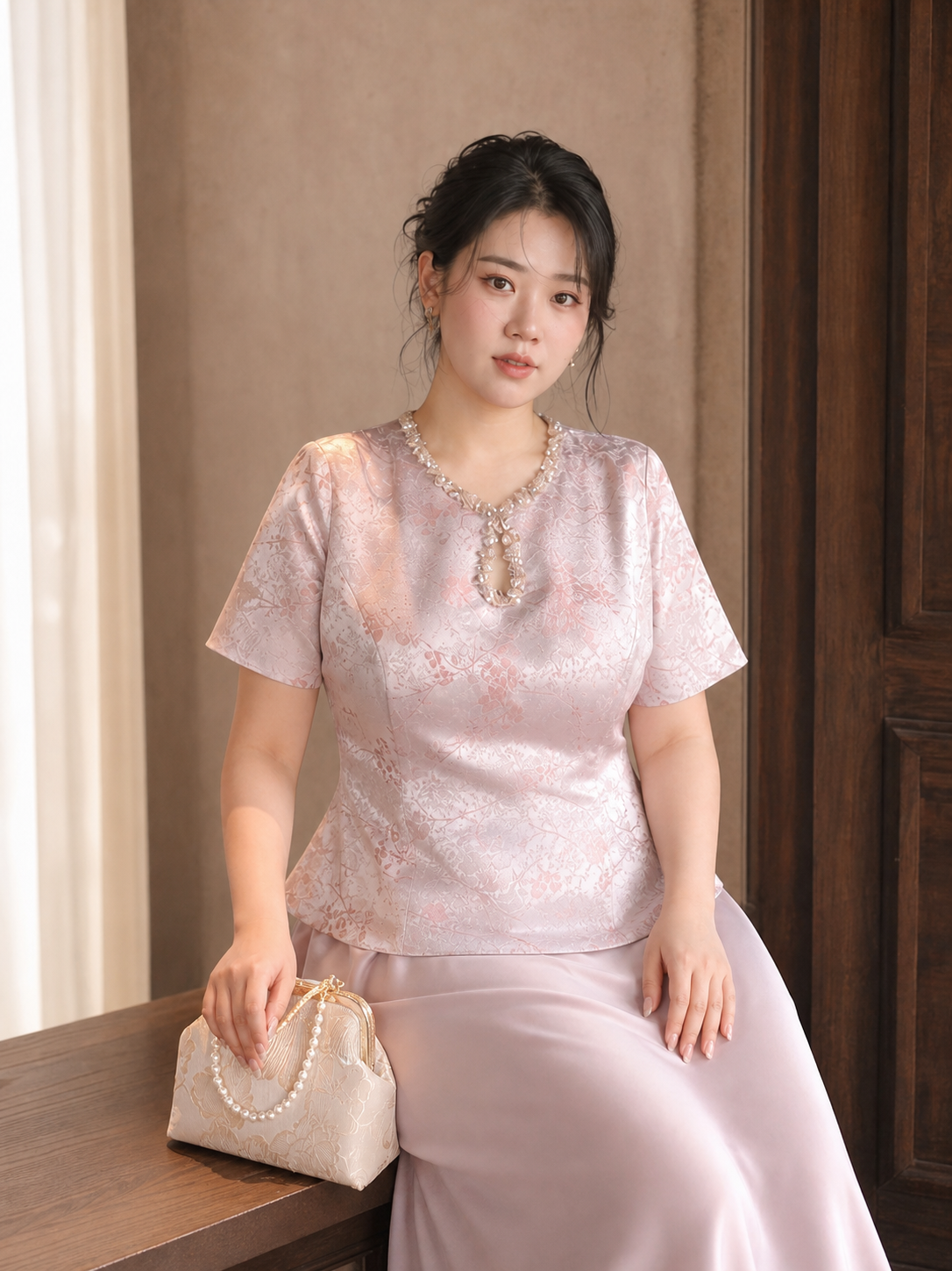 Pink Chinese engagement outfit close view of jeweled neckline and jacquard peplum