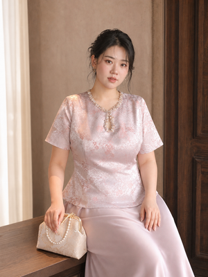 Pink Chinese engagement outfit close view of jeweled neckline and jacquard peplum