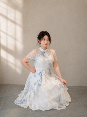 Plus size faux two-piece Chinese dress in blue, seated view showing layered skirt