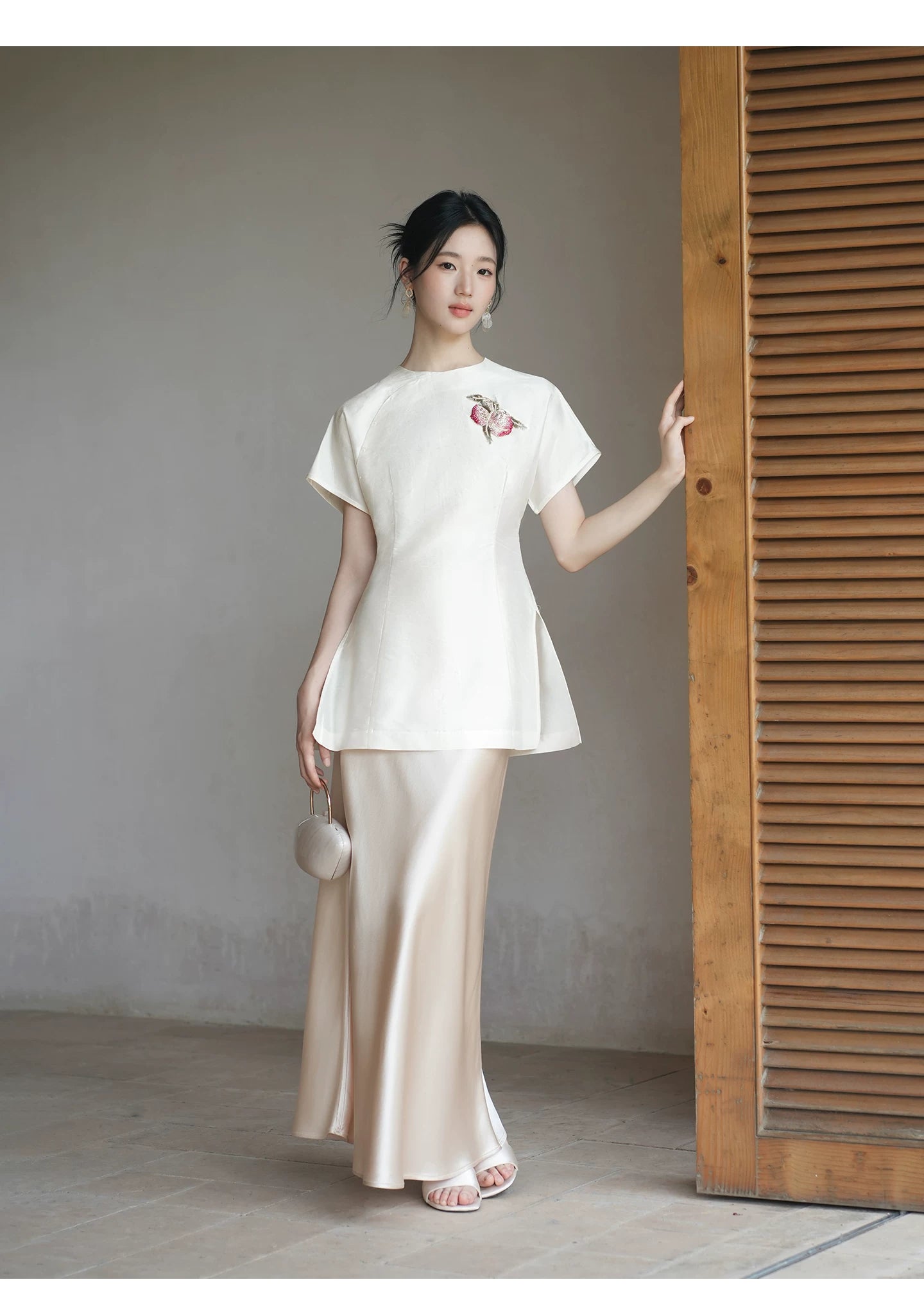 Detailed product image of the Porcelain-Moon mulberry silk top and champagne skirt, showing fabric texture, finish and craftsmanship.