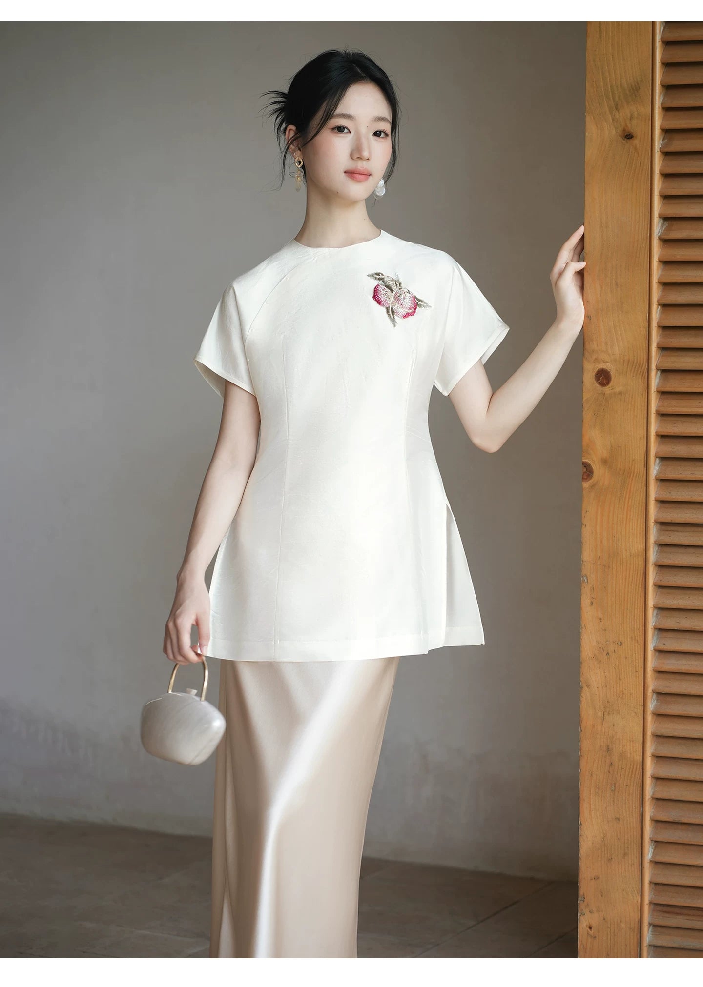 Close product view of the Porcelain-Moon mulberry silk top and champagne skirt, focused on its Chinese-inspired design details.