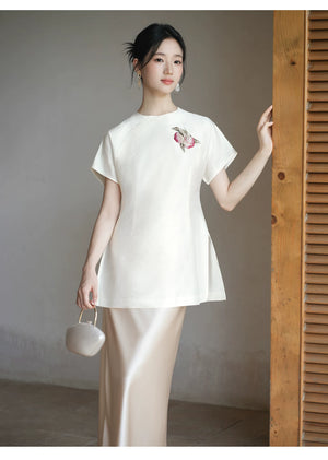 Close product view of the Porcelain-Moon mulberry silk top and champagne skirt, focused on its Chinese-inspired design details.