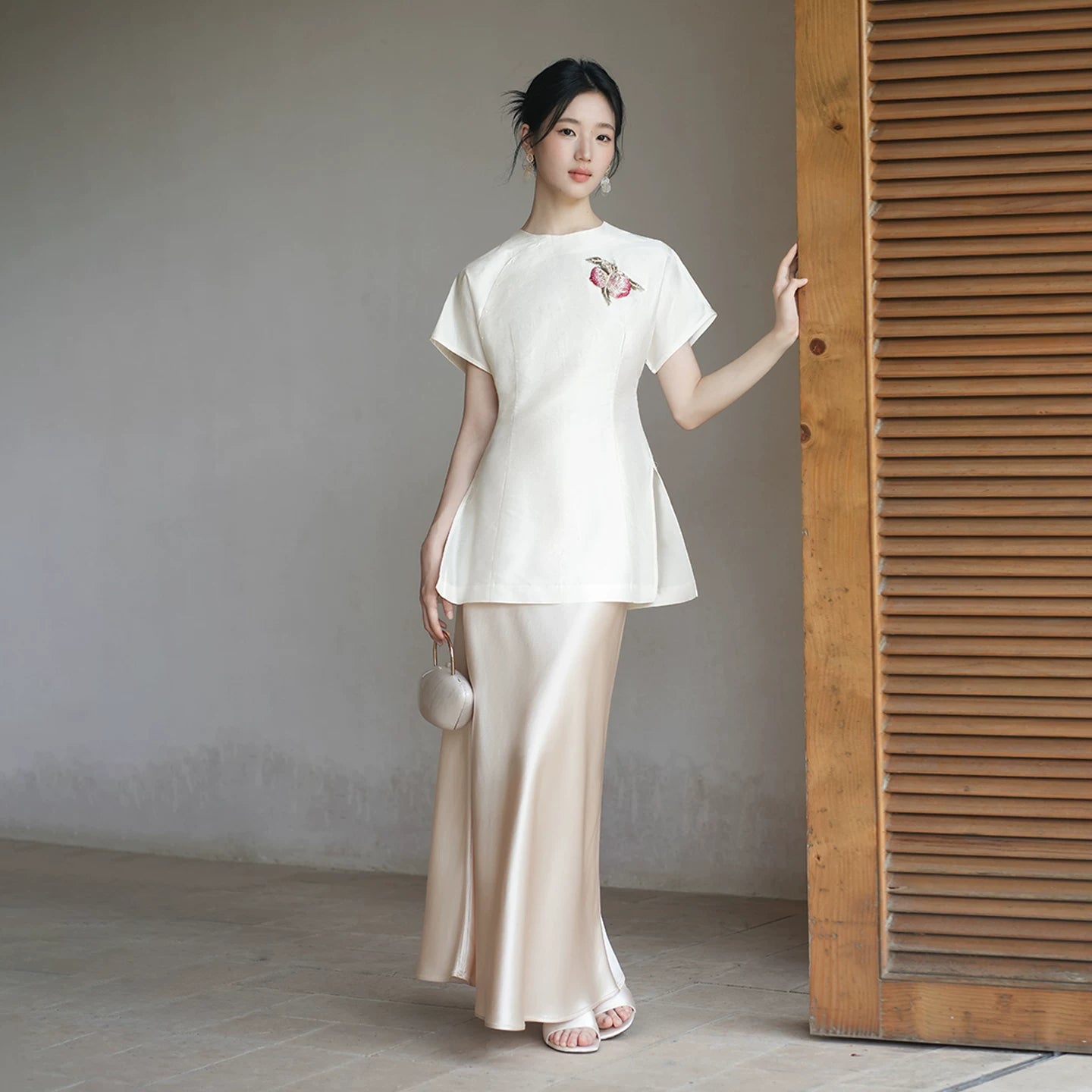 Detailed product image of the Porcelain-Moon mulberry silk top and champagne skirt, showing fabric texture, finish and craftsmanship.
