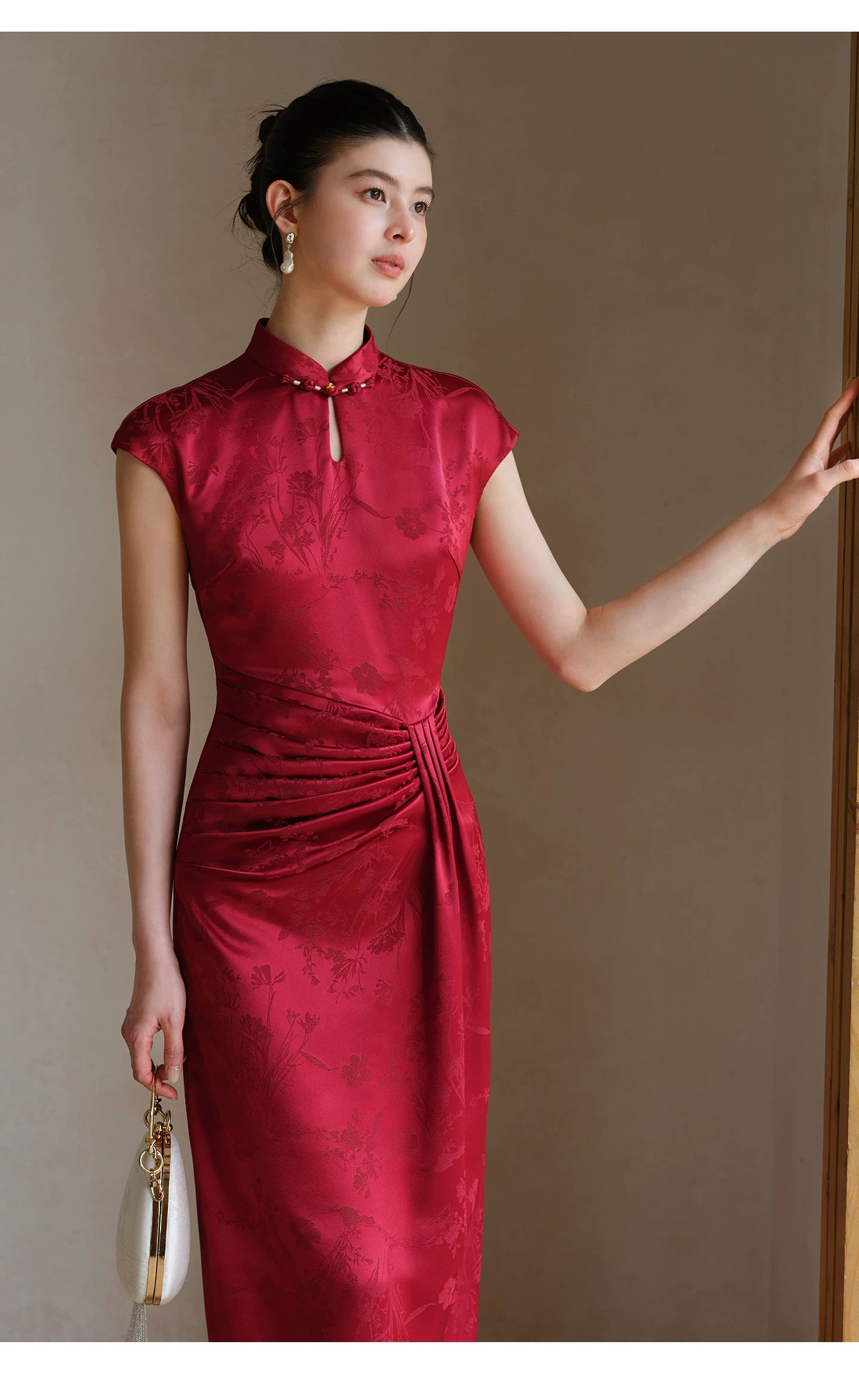 Detailed product image of the Ruby Red acetate jacquard pleated qipao dress, showing fabric texture, finish and craftsmanship.