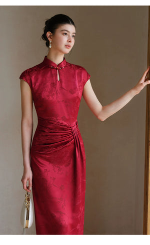 Detailed product image of the Ruby Red acetate jacquard pleated qipao dress, showing fabric texture, finish and craftsmanship.