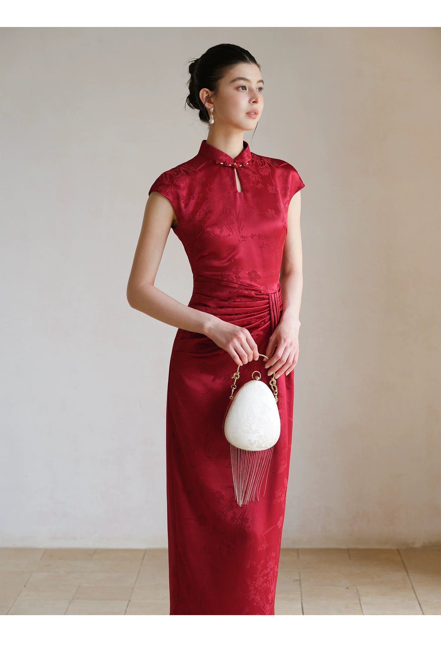 Close product view of the Ruby Red acetate jacquard pleated qipao dress, focused on its Chinese-inspired design details.