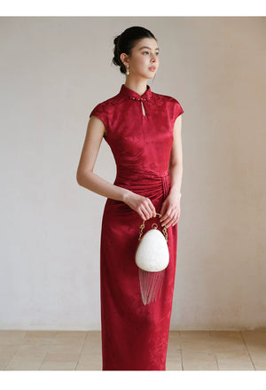 Close product view of the Ruby Red acetate jacquard pleated qipao dress, focused on its Chinese-inspired design details.